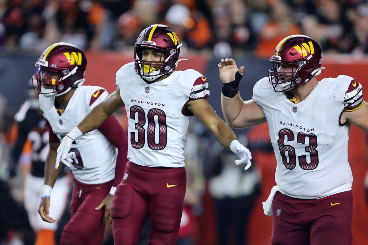 Sep 23, 2024; Cincinnati, Ohio, USA; Washington Commanders running back Austin Ekeler (30) celebrates his touchdown with quarterback Jayden Daniels (left) and center Tyler Biadasz (63) during the first quarter against the Cincinnati Bengals at Paycor Stadium. Mandatory Credit: Joseph Maiorana-Imagn Images