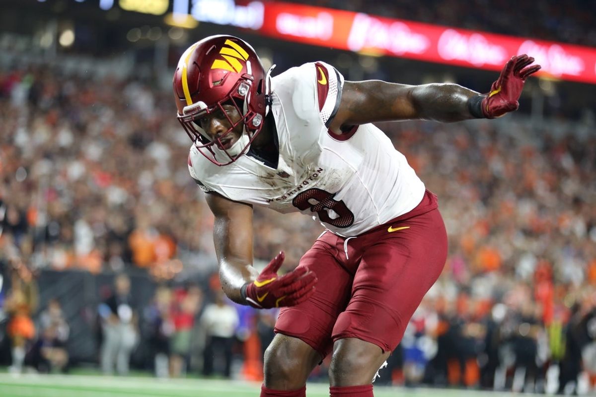 Sep 23, 2024; Cincinnati, Ohio, USA;  Washington Commanders running back Brian Robinson Jr. (8) celebrates a touchdown during the first quarter against the Cincinnati Bengals at Paycor Stadium. Mandatory Credit: Joseph Maiorana-Imagn Images
