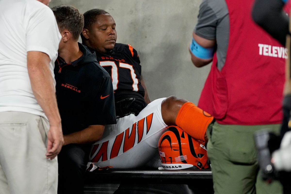 Cincinnati Bengals offensive tackle Trent Brown (77) is assisted off the field by the medical staff in the second quarter of the NFL Week 3 game between the Cincinnati Bengals and the Washington Commanders at Paycor Stadium in downtown Cincinnati on Monday, Sept. 23, 2024. The Commanders led 21-13 at halftime.
