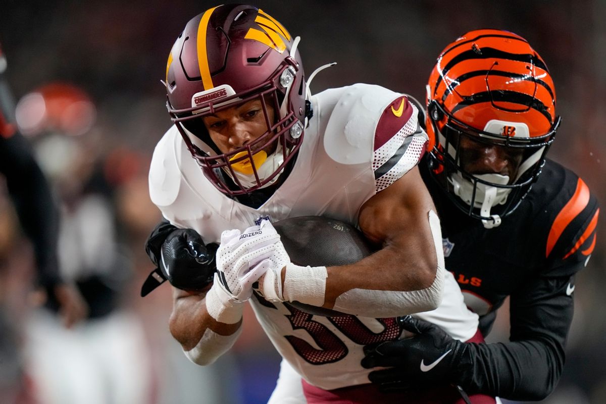 Washington Commanders running back Austin Ekeler (30) breaks away from Cincinnati Bengals safety Geno Stone (22) for a touchdown in the second quarter of the NFL Week 3 game between the Cincinnati Bengals and the Washington Commanders at Paycor Stadium in downtown Cincinnati on Monday, Sept. 23, 2024. The Commanders led 21-13 at halftime.