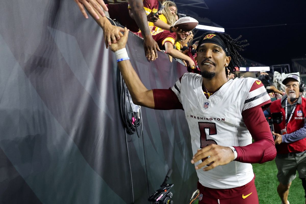 Sep 23, 2024; Cincinnati, Ohio, USA; Washington Commanders quarterback Jayden Daniels (5) celebrates with fans following the win against the Cincinnati Bengals at Paycor Stadium. Mandatory Credit: Joseph Maiorana-Imagn Images