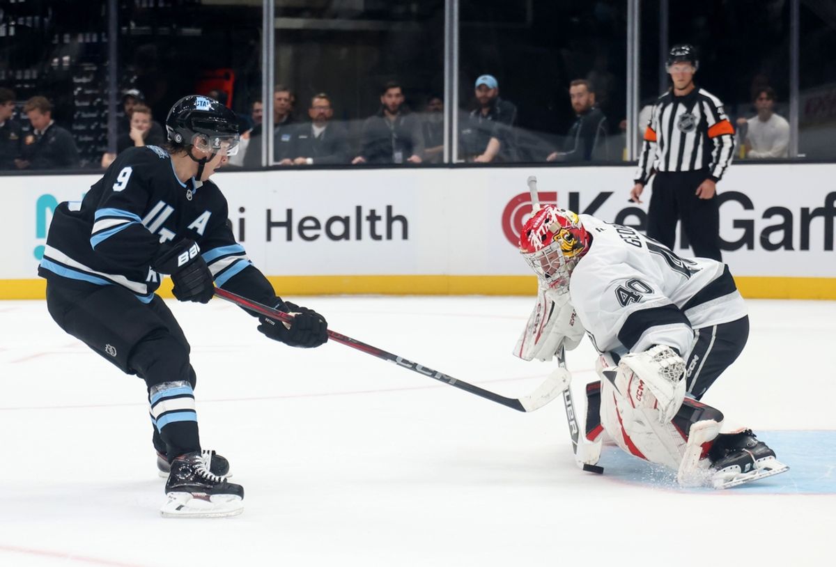 Sep 23, 2024; Salt Lake City, Utah, USA; Utah Hockey Club forward Clayton Keller (9) shoots against Los Angeles Kings goaltender Carter George} (40) during a shootout at Delta Center. Mandatory Credit: Rob Gray-Imagn Images