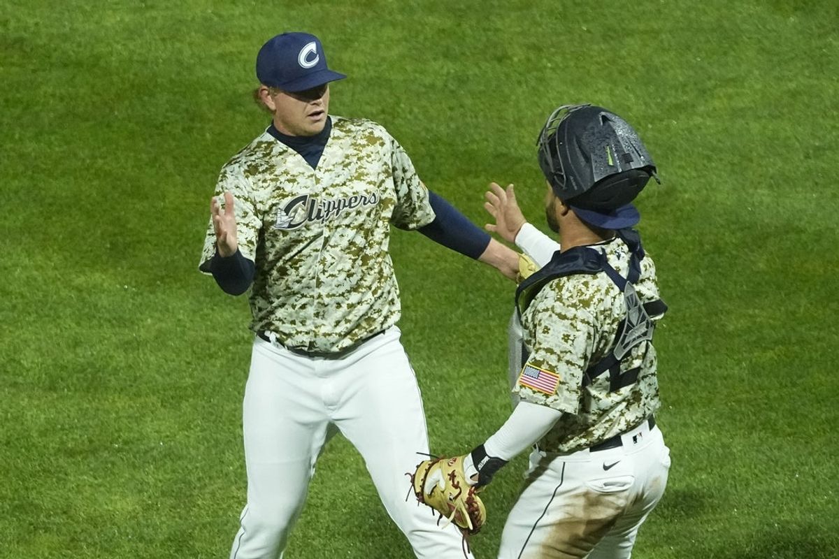 Apr 3, 2024; Columbus, OH, USA; Columbus Clippers pitcher Nic Enright (39) high fives catcher Bryan Lavastida (27) to celebrate their 3-0 win over the Omaha Storm Chasers during Opening Day at Huntington Park.