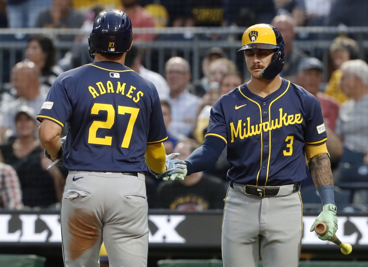 Sep 24, 2024; Pittsburgh, Pennsylvania, USA; Milwaukee Brewers third baseman Joey Ortiz (3) greets shortstop Willy Adames (27) crossing home plate to score a run against the Pittsburgh Pirates during the second inning at PNC Park. Mandatory Credit: Charles LeClaire-Imagn Images