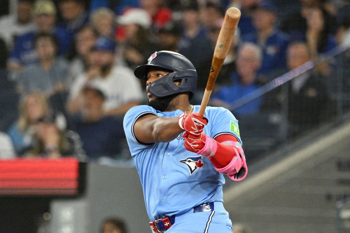 Sep 24, 2024; Toronto, Ontario, CAN; Toronto Blue Jays designated hitter Vladimir Guerrero Jr. (27) hits a two run RBI double against the Boston Red Sox in the third inning at Rogers Centre. Mandatory Credit: Dan Hamilton-Imagn Images
