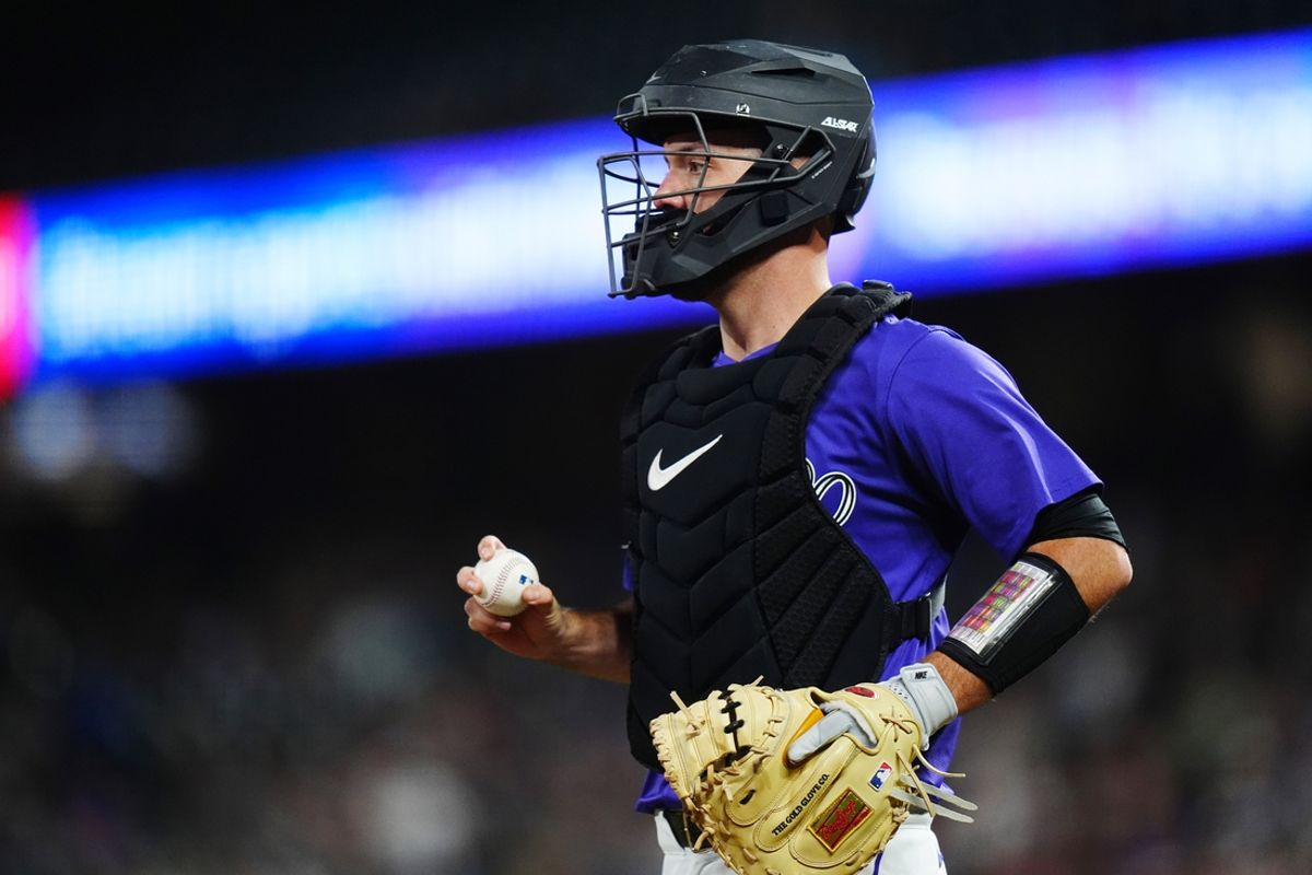 Sep 24, 2024; Denver, Colorado, USA; Colorado Rockies catcher Jacob Stallings (25) during a run down in the seventh inning against the St. Louis Cardinals at Coors Field. Mandatory Credit: Ron Chenoy-Imagn Images