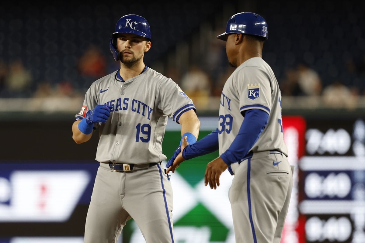Sep 25, 2024; Washington, District of Columbia, USA; Kansas City Royals second baseman Michael Massey (19) celebrates with Royals first baseman coach Damon Hollins (39) at first base after hitting an RBI single against the Washington Nationals during the third inning at Nationals Park. Mandatory Credit: Geoff Burke-Imagn Images