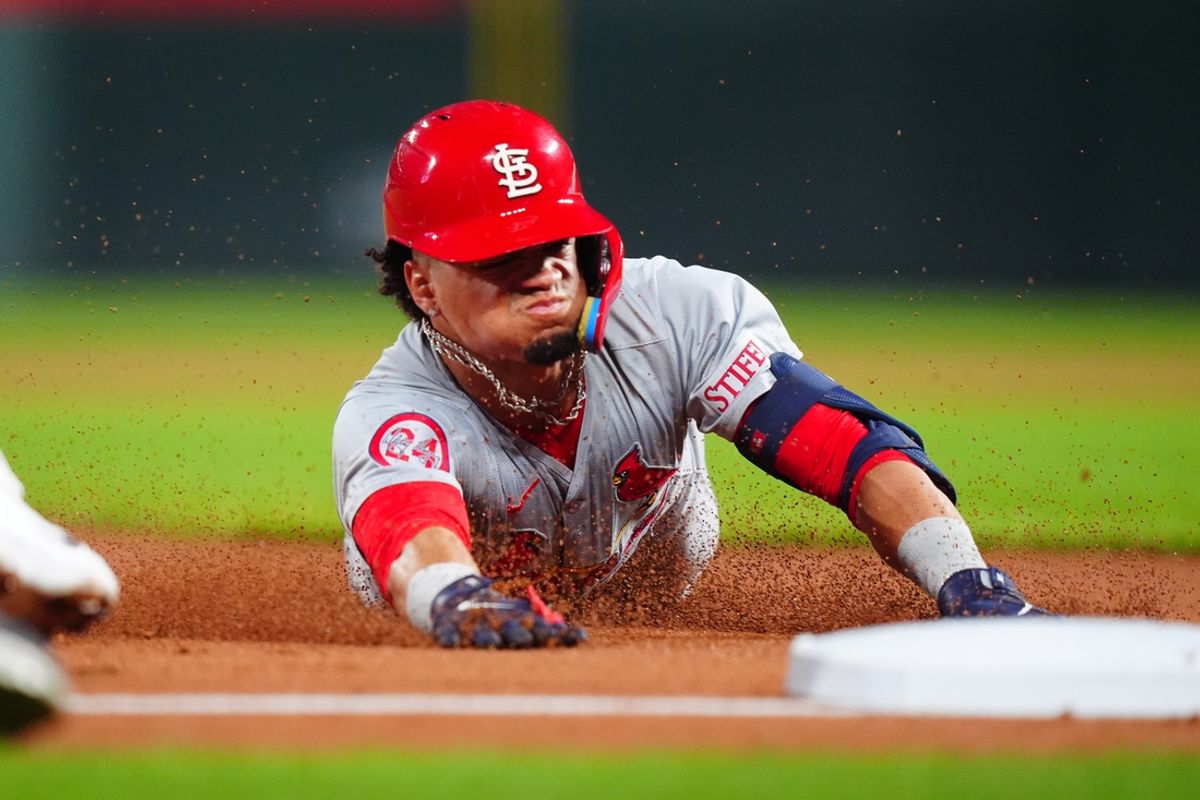 Sep 25, 2024; Denver, Colorado, USA; St. Louis Cardinals shortstop Masyn Winn (0) slides for a triple in the third inning against the Colorado Rockies at Coors Field. Mandatory Credit: Ron Chenoy-Imagn Images