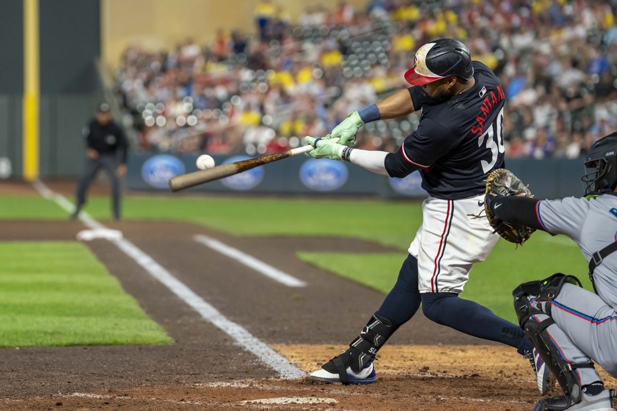 Sep 25, 2024; Minneapolis, Minnesota, USA; Minnesota Twins first baseman Carlos Santana (30) hits an RBI double against the Miami Marlins in the seventh inning at Target Field. Mandatory Credit: Jesse Johnson-Imagn Images