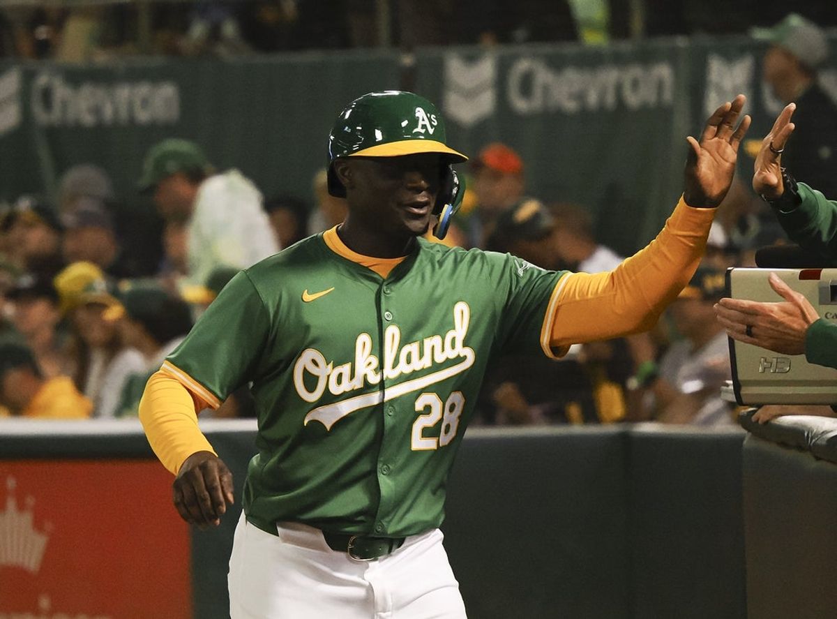 Sep 25, 2024; Oakland, California, USA; Oakland Athletics center fielder Daz Cameron (28) celebrates after scoring a run against the Texas Rangers during the second inning at Oakland-Alameda County Coliseum. Mandatory Credit: Kelley L Cox-Imagn Images