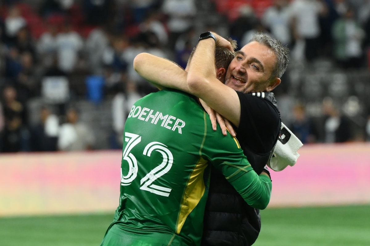 Sep 25, 2024; Vancouver, British Columbia, CAN;  Vancouver Whitecaps FC head coach Vanni Sartini hugs goalkeeper Isaac Boehmer (32) after the win against Toronto FC at BC Place. Mandatory Credit: Anne-Marie Sorvin-Imagn Images