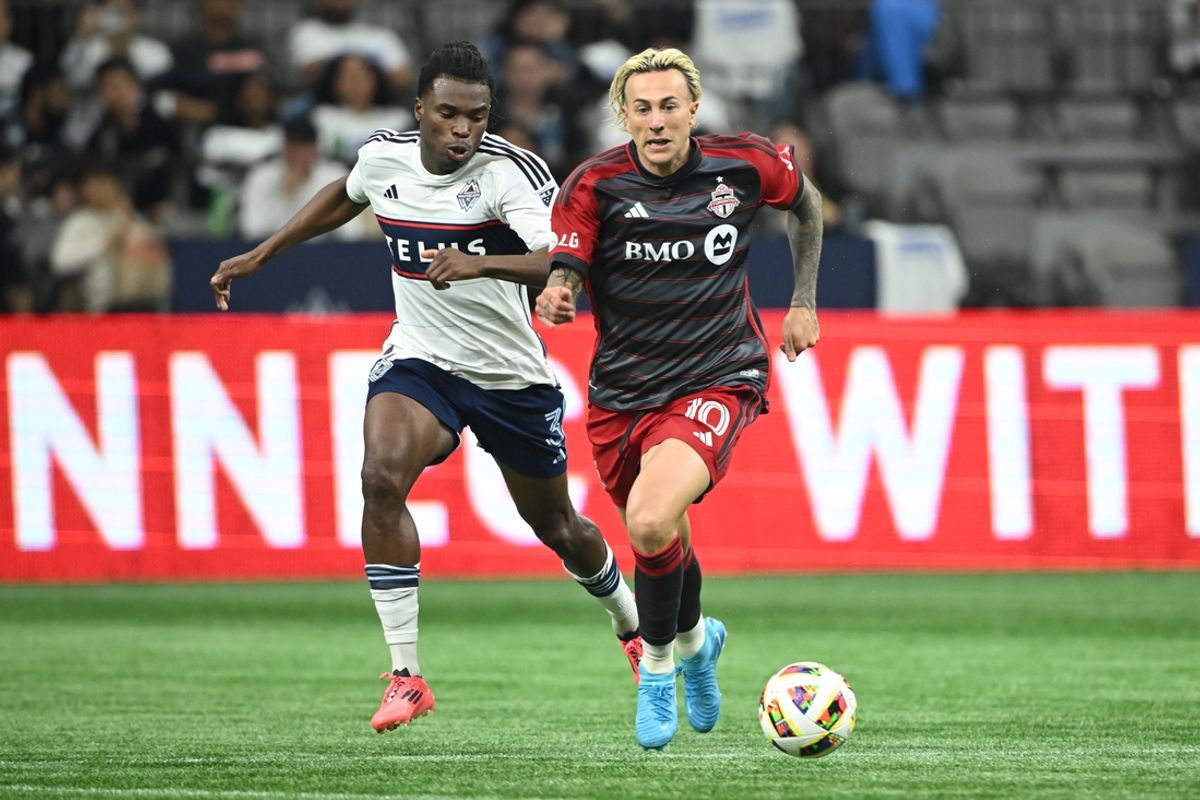 Sep 25, 2024; Vancouver, British Columbia, CAN;  Toronto FC forward Federico Bernardeschi (10) dribbles the ball against Vancouver Whitecaps FC defender Sam Adekugbe (3) during the second half at BC Place. Mandatory Credit: Anne-Marie Sorvin-Imagn Images