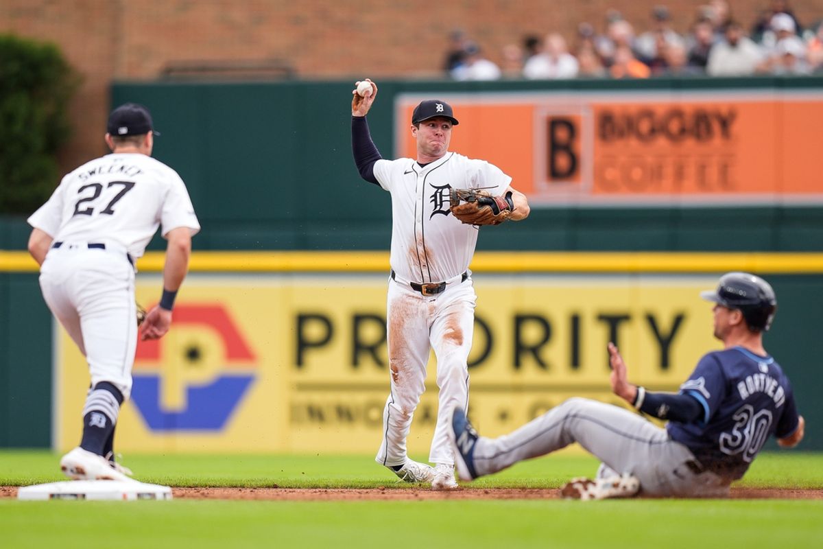 Detroit Tigers second base Colt Keith (33) throws toward first base as Tampa Bay Rays catcher Ben Rortvedt (30) slides into second base during the second inning at Comerica Park in Detroit on Thursday, Sept. 26, 2024.