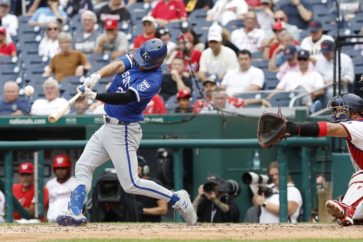 Sep 26, 2024; Washington, District of Columbia, USA; Kansas City Royals second baseman Adam Frazier (26) hits a two run single against the Washington Nationals during the ninth inning at Nationals Park. Mandatory Credit: Geoff Burke-Imagn Images