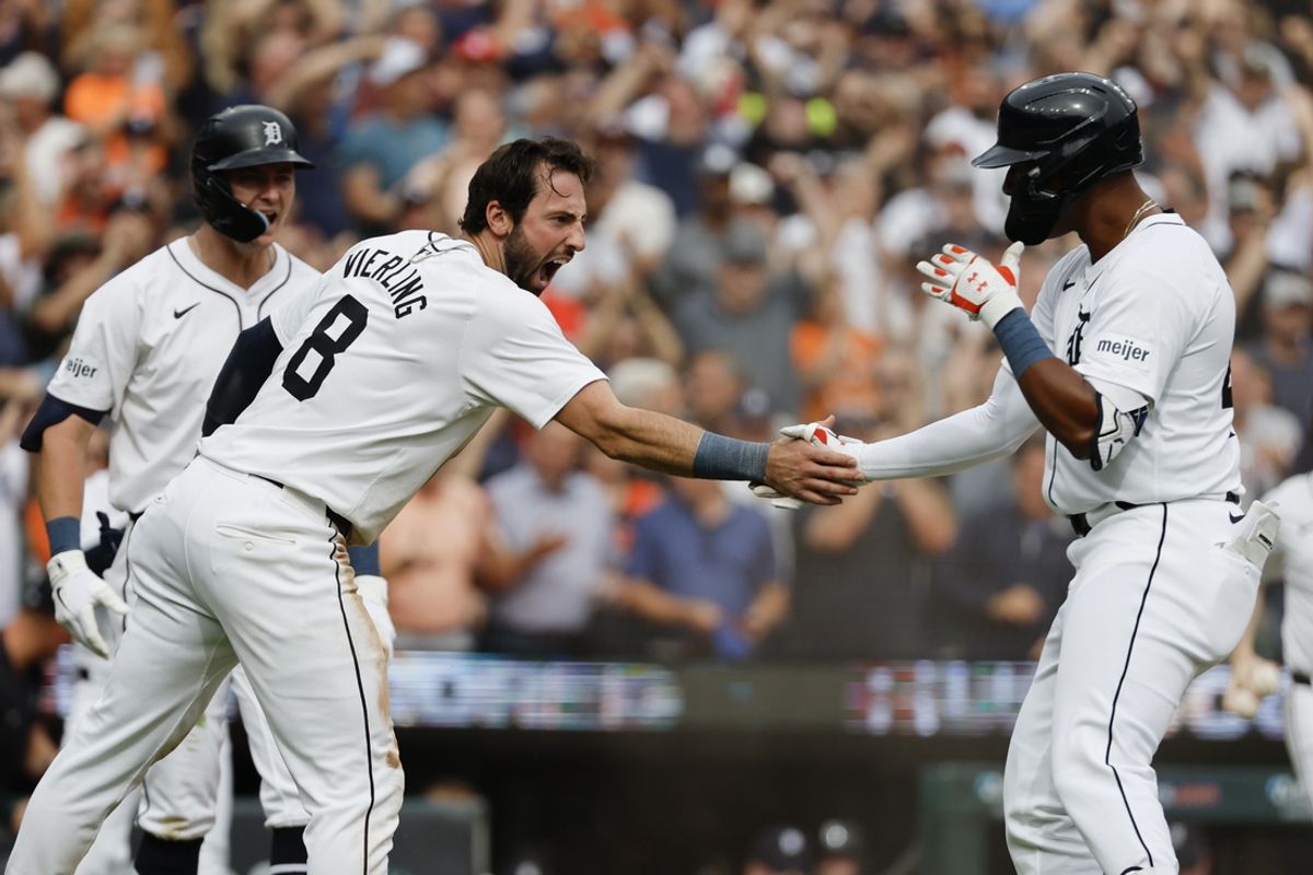 Sep 26, 2024; Detroit, Michigan, USA;  Detroit Tigers center fielder Matt Vierling (8) celebrates with left fielder Justyn-Henry Malloy (44) after he dives in safe at home in the eighth inning against the Tampa Bay Rays at Comerica Park. Mandatory Credit: Rick Osentoski-Imagn Images