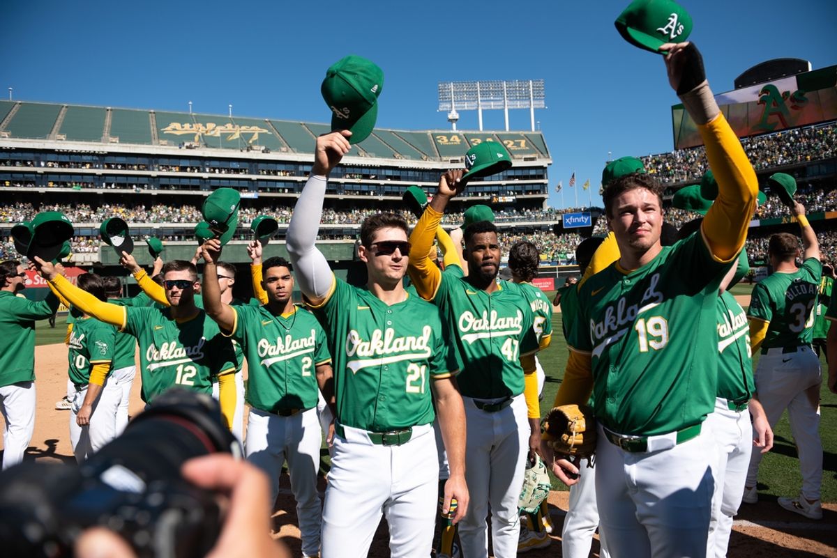 Sep 26, 2024; Oakland, California, USA; Oakland Athletics players tip their caps to the crowd after the game against the Texas Rangers at Oakland-Alameda County Coliseum. Mandatory Credit: Ed Szczepanski-Imagn Images