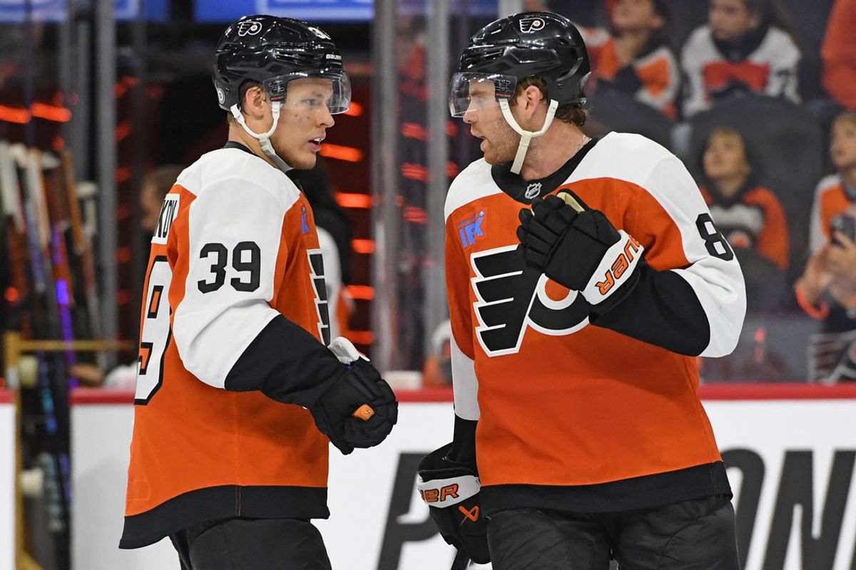 Sep 26, 2024; Philadelphia, Pennsylvania, USA; Philadelphia Flyers right wing Matvei Michkov (39) talks with Philadelphia Flyers defenseman Cam York (8) against the New York Islanders during the second period at Wells Fargo Center. Mandatory Credit: Eric Hartline-Imagn Images