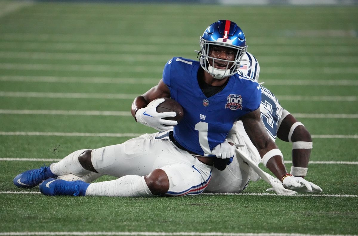 Sep 26, 2024; East Rutherford, New Jersey, USA;  New York Giants wide receiver Malik Nabers (1) on a short gain against Dallas Cowboys linebacker DeMarvion Overshown (13) during the first half at MetLife Stadium. Mandatory Credit: Robert Deutsch-Imagn Images