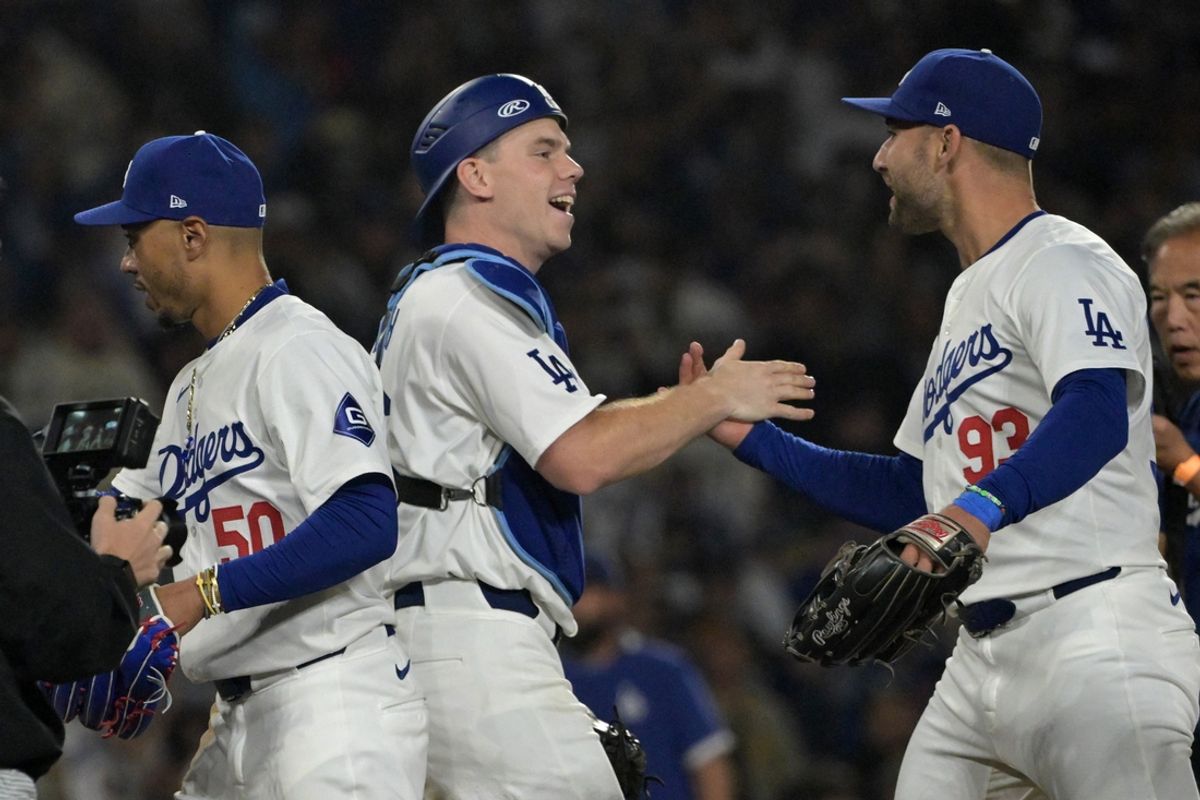 Sep 26, 2024; Los Angeles, California, USA;  Los Angeles Dodgers catcher Will Smith (16) and center fielder Kevin Kiermaier (93) after clinching the National League West by defeating the San Diego Padres 7-2 at Dodger Stadium. Mandatory Credit: Jayne Kamin-Oncea-Imagn Images