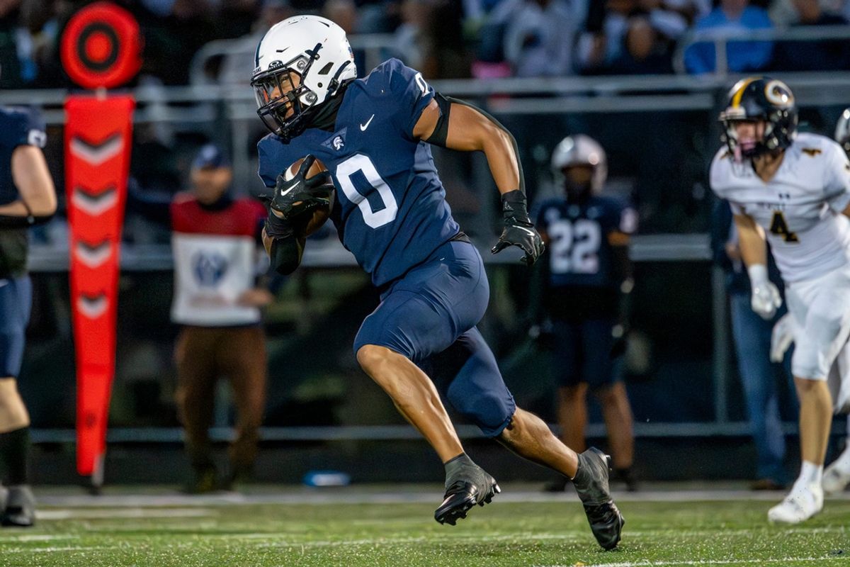 East Lansing's Jace Clarizio runs for a gain against DeWitt during the second quarter on Friday, Sept. 27, 2024, at East Lansing High School.