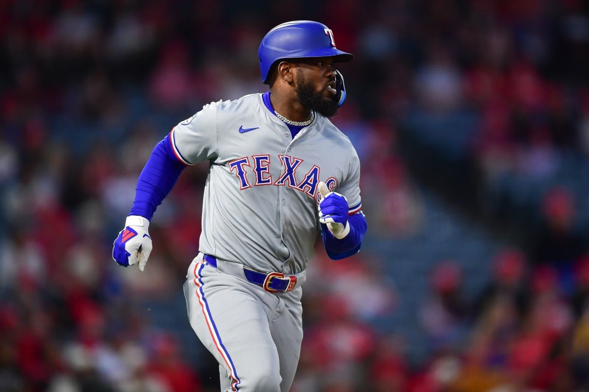 Sep 27, 2024; Anaheim, California, USA; Texas Rangers right fielder Adolis Garcia (53) hits a solo home run against the Los Angeles Angels during the first inning at Angel Stadium. Mandatory Credit: Gary A. Vasquez-Imagn Images
