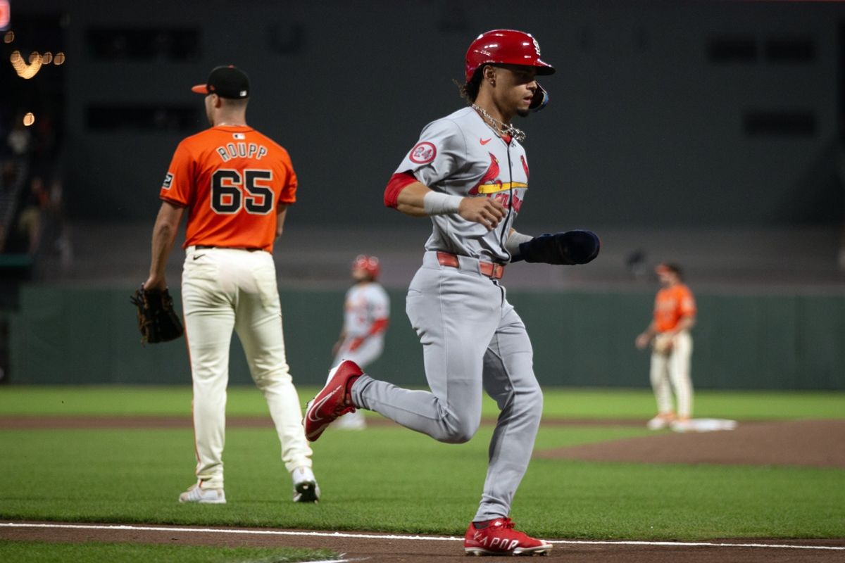 Sep 27, 2024; San Francisco, California, USA; St. Louis Cardinals shortstop Masyn Winn (0) scores on a single by Nolan Arenado as San Francisco Giants starting pitcher Landen Roupp (65) watches the action during the first inning at Oracle Park. Mandatory Credit: D. Ross Cameron-Imagn Images