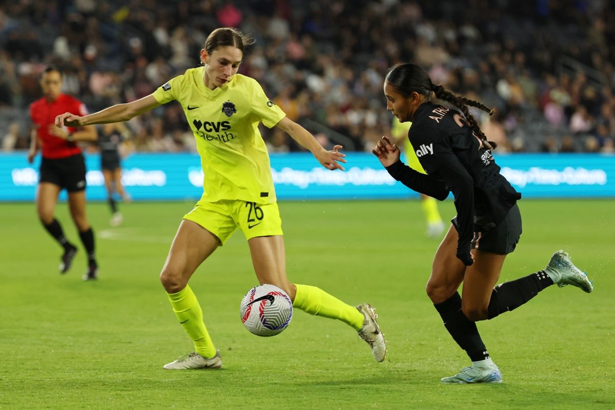 Sep 27, 2024; Los Angeles, California, USA; Angel City FC midfielder Alyssa Thompson (21) dribbles the ball against Washington Spirit midfielder Paige Metayer (26) during the second half at BMO Stadium. Mandatory Credit: Kiyoshi Mio-Imagn Images