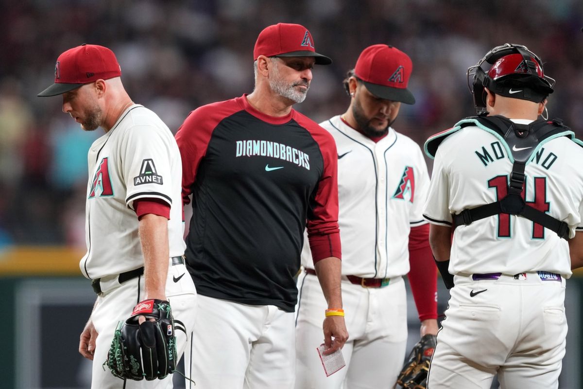 Sep 27, 2024; Phoenix, Arizona, USA; Arizona Diamondbacks manager Torey Lovullo (17) takes Arizona Diamondbacks pitcher Merrill Kelly (29) out of the game against the San Diego Padres during the sixth inning at Chase Field. Mandatory Credit: Joe Camporeale-Imagn Images
