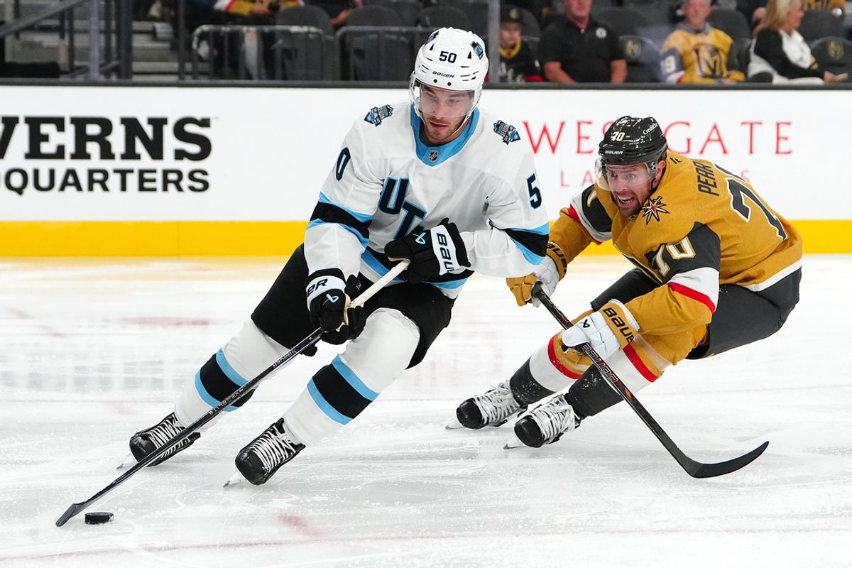 Sep 27, 2024; Las Vegas, Nevada, USA; Utah Hockey Club defenseman Sean Durzi (50) skates ahead of Vegas Golden Knights forward Tanner Pearson (70) during the second period at T-Mobile Arena. Mandatory Credit: Stephen R. Sylvanie-Imagn Images