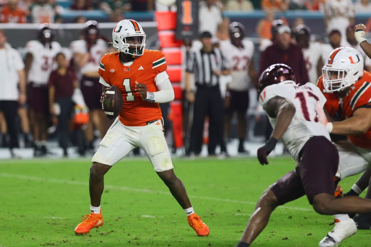 Sep 27, 2024; Miami Gardens, Florida, USA; Miami Hurricanes quarterback Cam Ward (1) looks for a passing option against the Virginia Tech Hokies during the fourth quarter at Hard Rock Stadium. Mandatory Credit: Sam Navarro-Imagn Images
