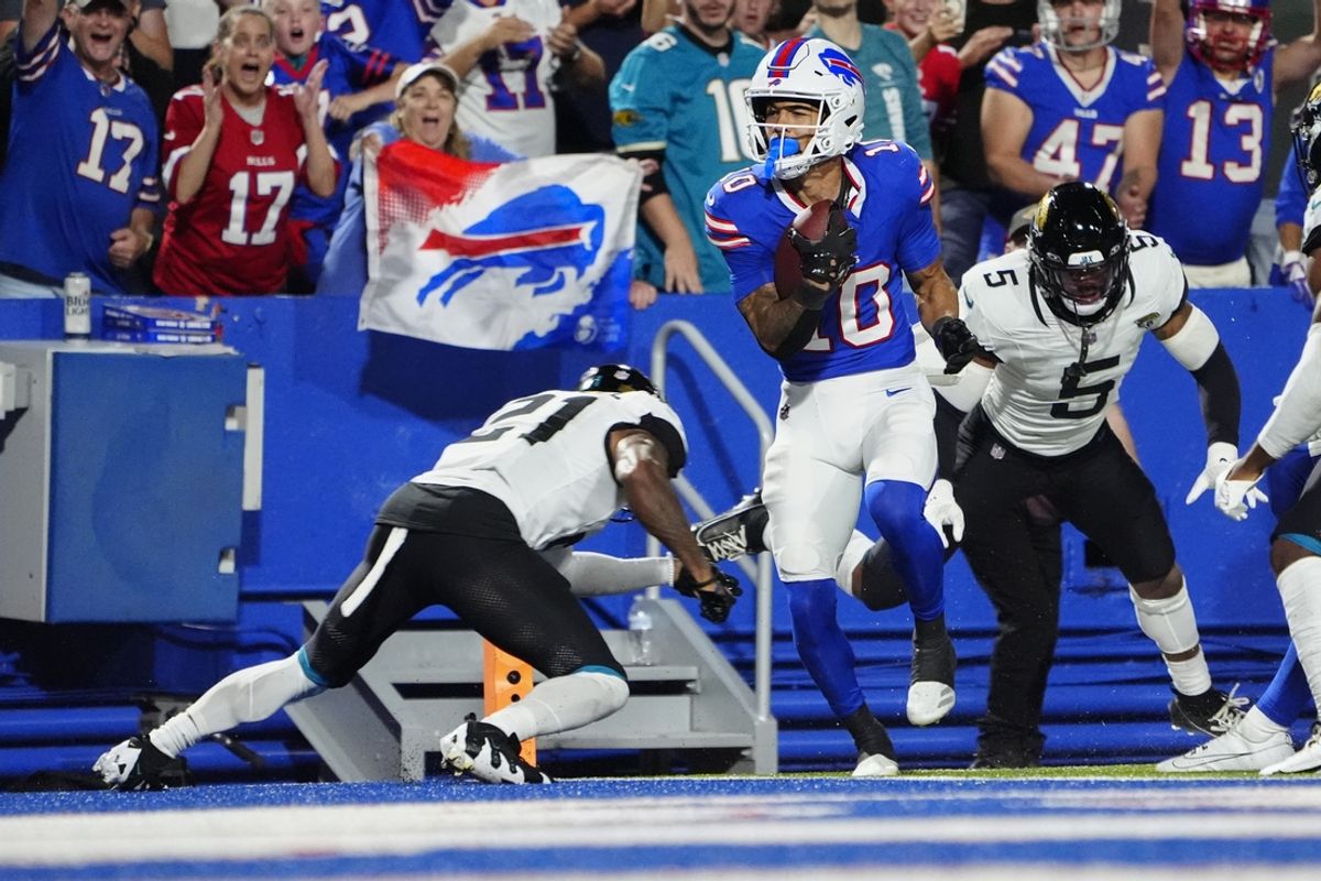 Sep 23, 2024; Orchard Park, New York, USA; Buffalo Bills wide receiver Khalil Shakir (10) runs with the ball after making a catch for a touchdown against Jacksonville Jaguars cornerback 	Christian Braswell (21) during the first half at Highmark Stadium. Mandatory Credit: Gregory Fisher-Imagn Images