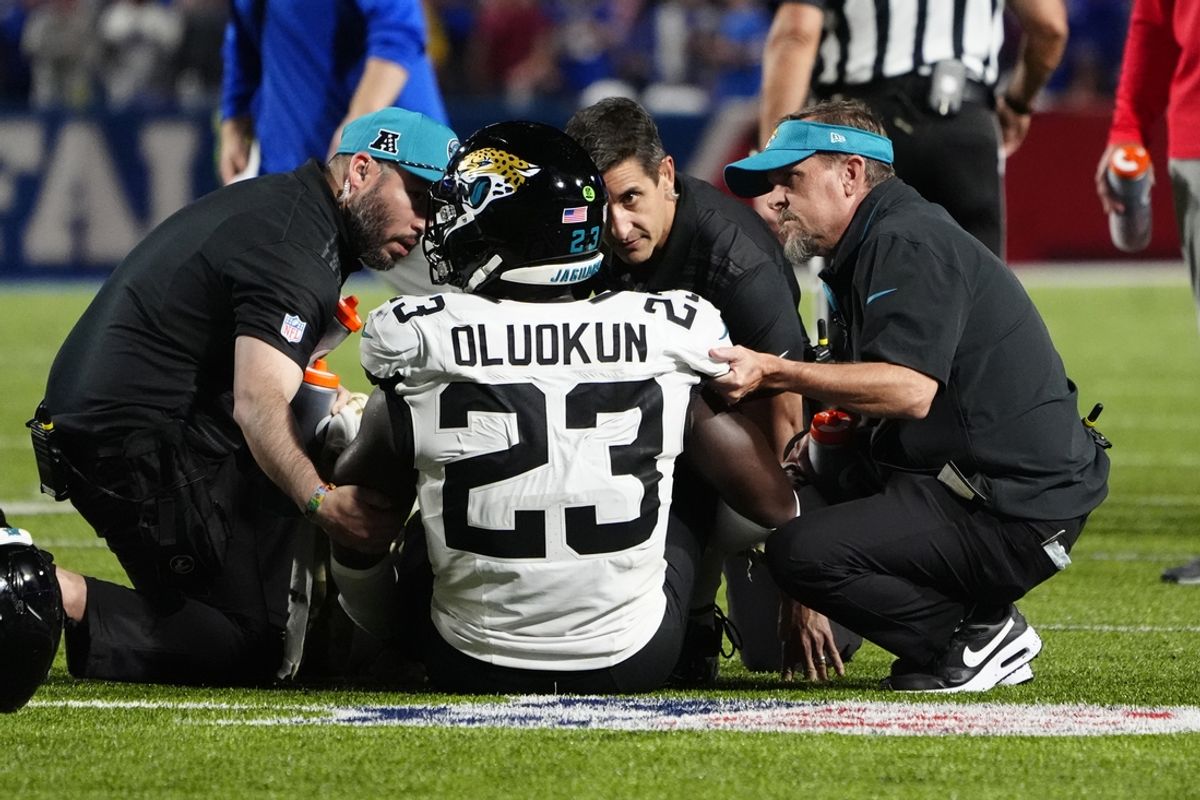 Sep 23, 2024; Orchard Park, New York, USA; Jacksonville Jaguars linebacker Foyesade Oluokun (23) is attended to by the training staff after suffering an injury on the previous play against the Buffalo Bills during the first half at Highmark Stadium. Mandatory Credit: Gregory Fisher-Imagn Images