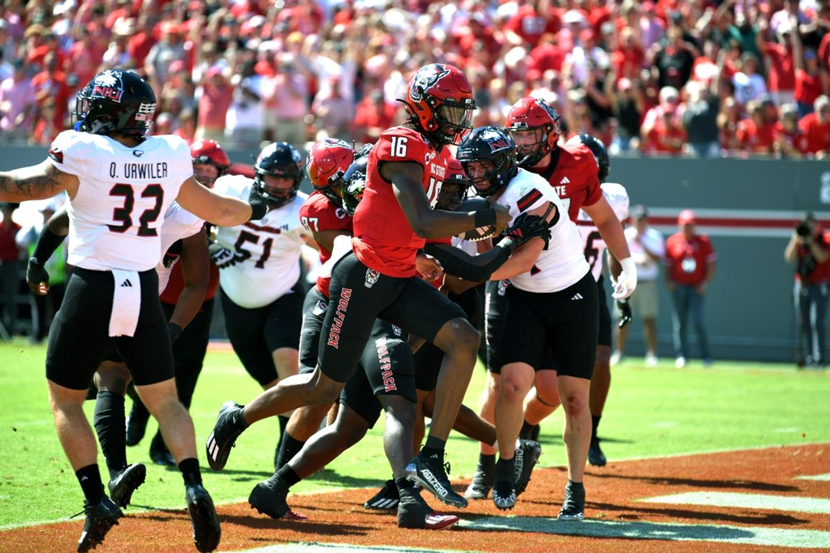 Sep 28, 2024; Raleigh, North Carolina, USA; North Carolina State Wolfpack quarterback CJ Bailey (16) runs ball into end zone against the Northern Illinois Huskies in the first quarter at Carter-Finley Stadium. Mandatory Credit: Zachary Taft-Imagn Images