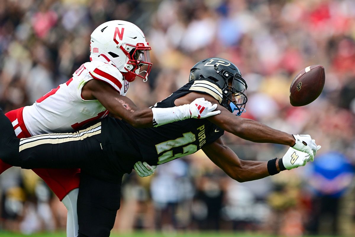 Sep 28, 2024; West Lafayette, Indiana, USA; Purdue Boilermakers wide receiver Jaron Tibbs (13) cannot catch a pass against Nebraska Cornhuskers defensive back Ceyair Wright (15) during the second quarter at Ross-Ade Stadium. Mandatory Credit: Marc Lebryk-Imagn Images