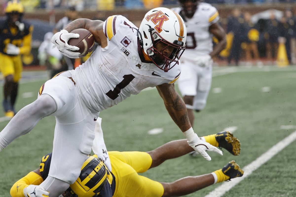 Sep 28, 2024; Ann Arbor, Michigan, USA;  Minnesota Golden Gophers running back Darius Taylor (1) is tackled by Michigan Wolverines defensive back Jyaire Hill (20) in the first half at Michigan Stadium. Mandatory Credit: Rick Osentoski-Imagn Images