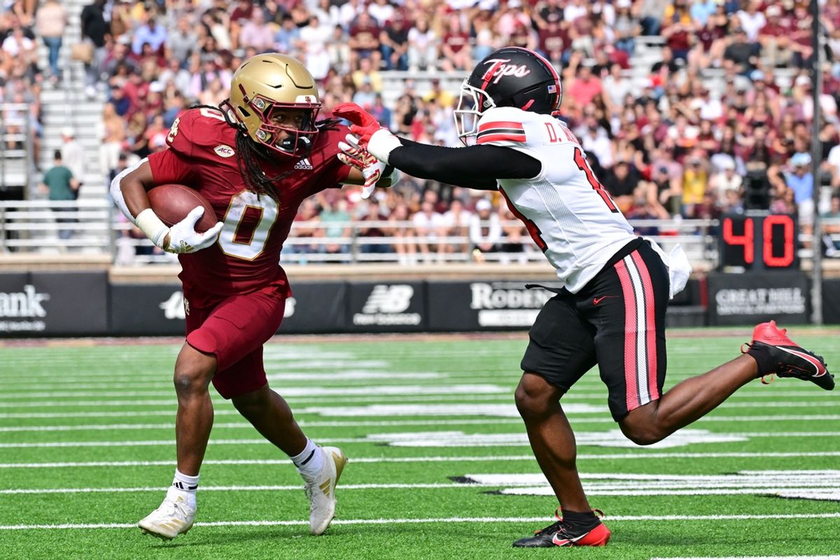Sep 28, 2024; Chestnut Hill, Massachusetts, USA; Boston College Eagles running back Treshaun Ward (0) runs the ball against Western Kentucky Hilltoppers defensive back Devonte' Mathews (14) during the first half at Alumni Stadium. Mandatory Credit: Eric Canha-Imagn Images