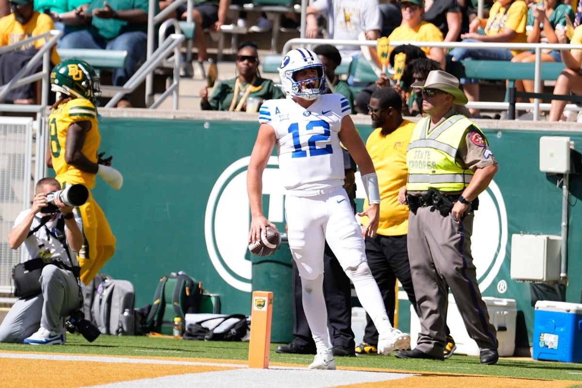 Sep 28, 2024; Waco, Texas, USA;  Brigham Young Cougars quarterback Jake Retzlaff (12) celebrates after scoring a touchdown against the Baylor Bears during the first half at McLane Stadium. Mandatory Credit: Chris Jones-Imagn Images