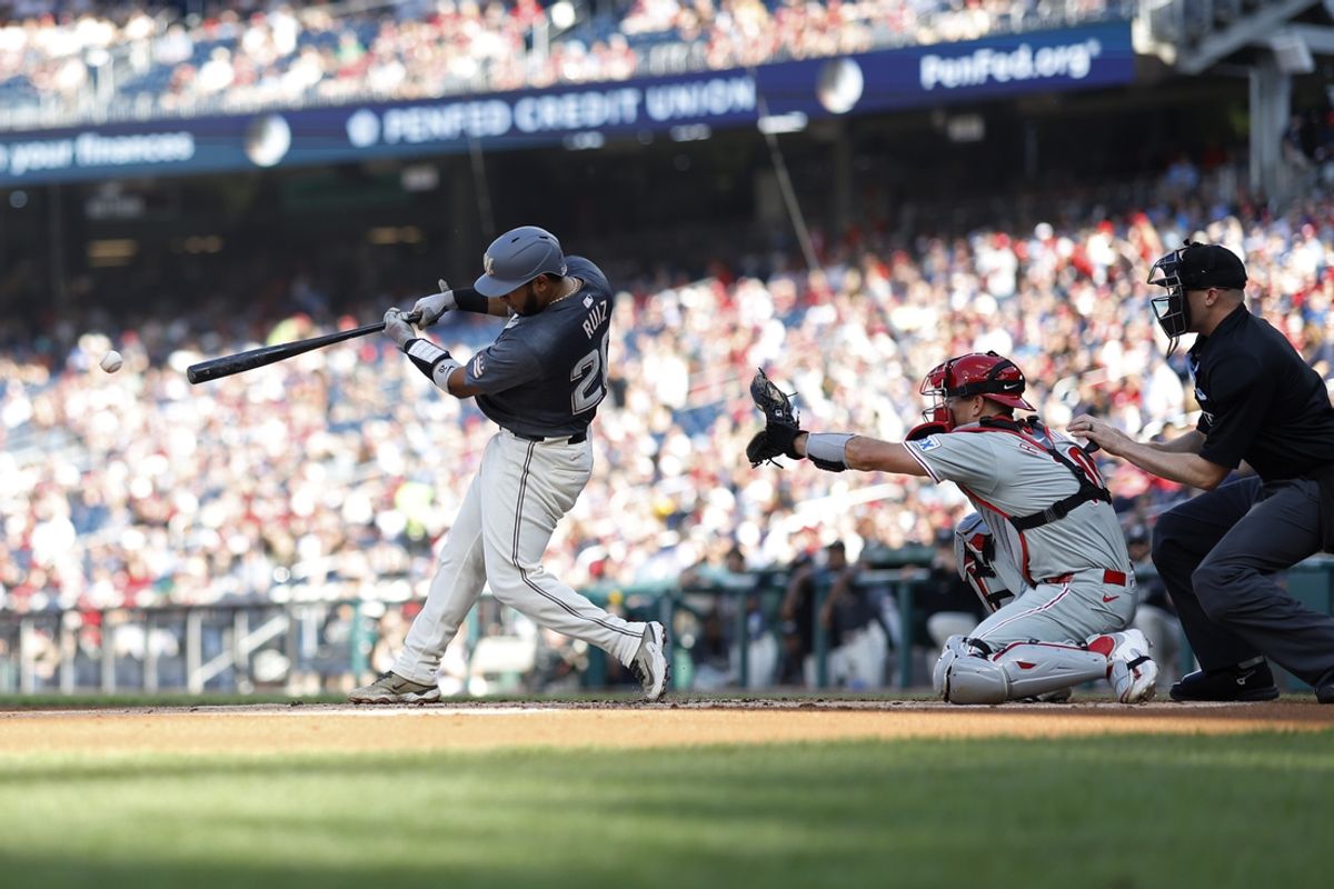 Sep 28, 2024; Washington, District of Columbia, USA; Washington Nationals catcher Keibert Ruiz (20) singles against the Philadelphia Phillies during the first inning at Nationals Park. Mandatory Credit: Geoff Burke-Imagn Images