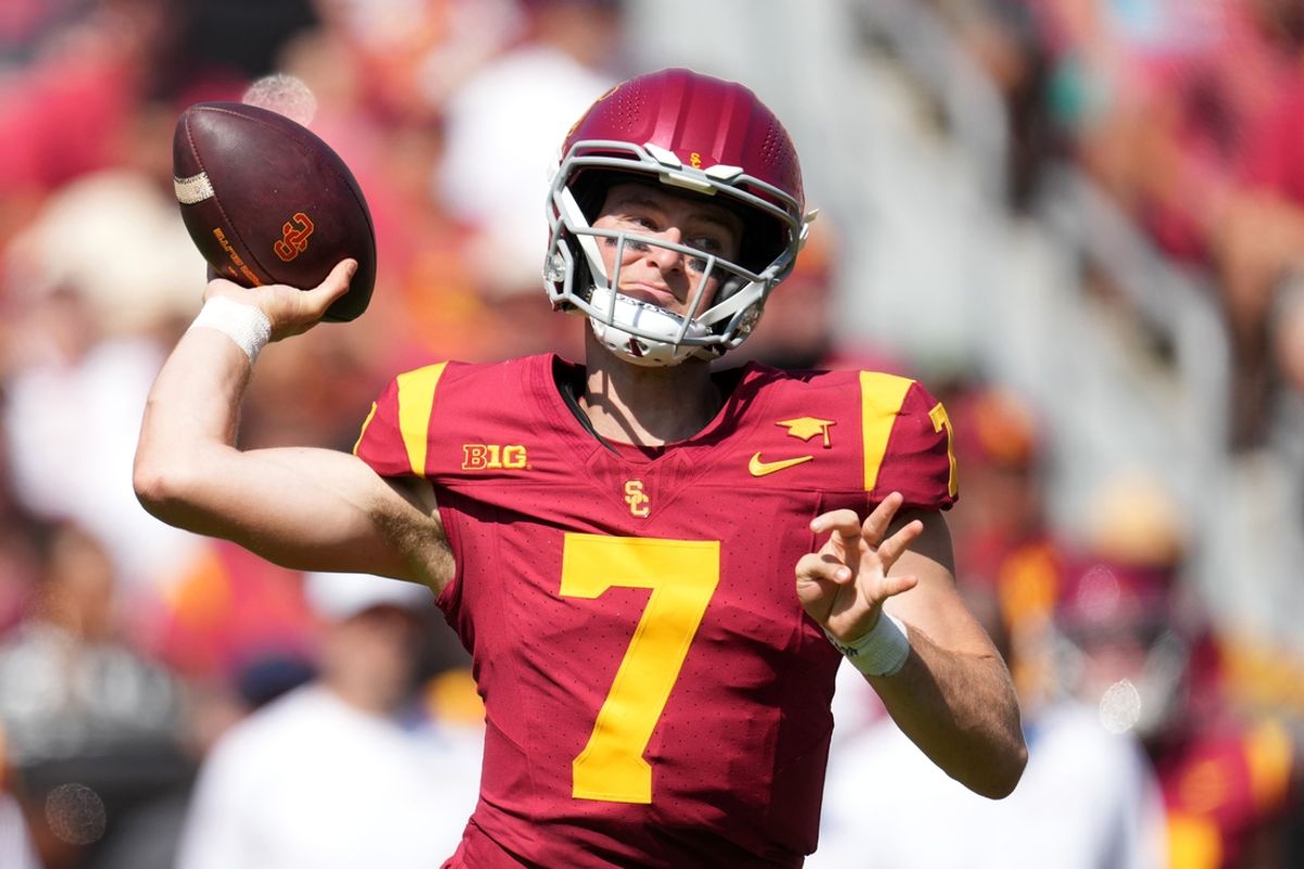 Sep 28, 2024; Los Angeles, California, USA; Southern California Trojans quarterback Miller Moss (7) throws the ball against the Wisconsin Badgers in the first half at United Airlines Field at Los Angeles Memorial Coliseum. Mandatory Credit: Kirby Lee-Imagn Images