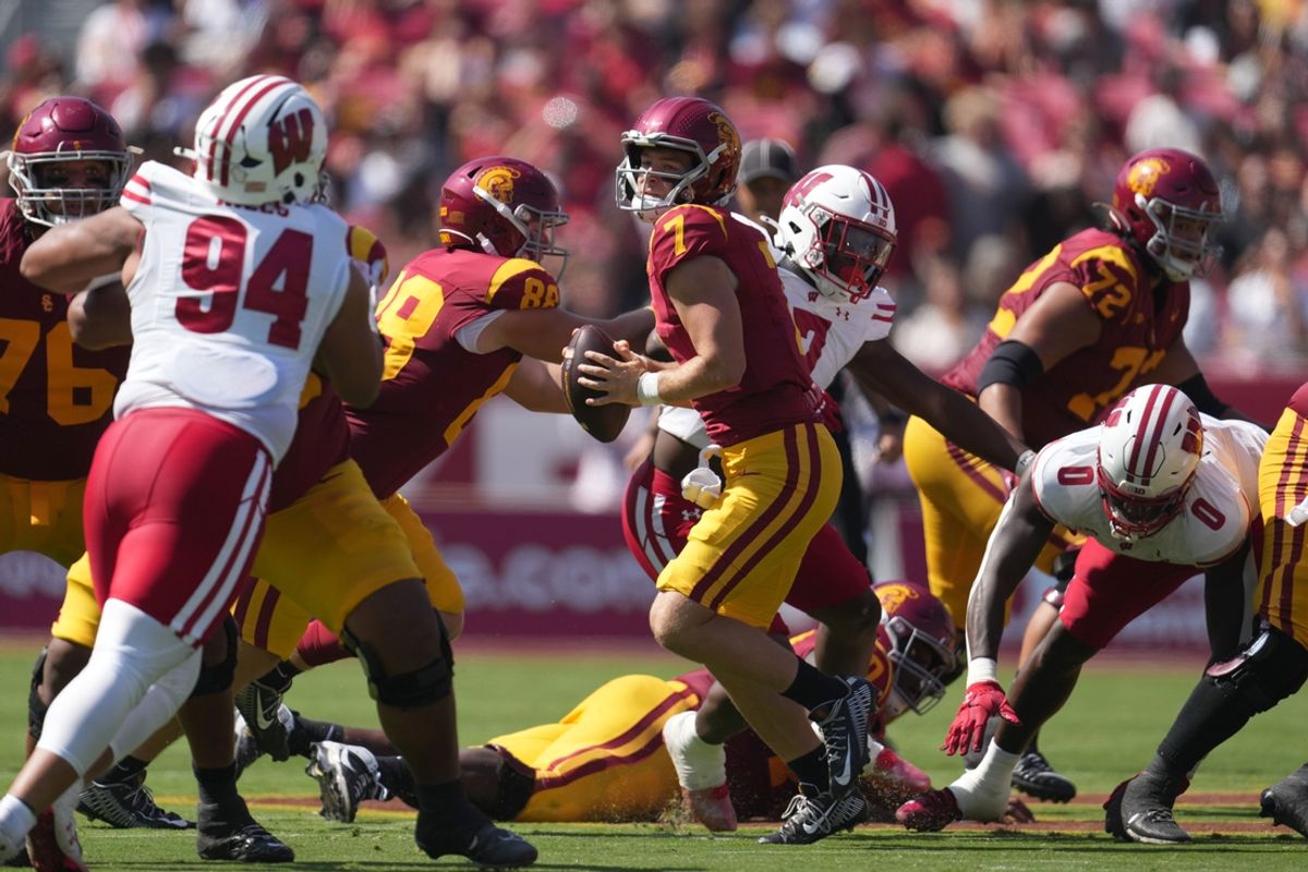 Sep 28, 2024; Los Angeles, California, USA; Southern California Trojans quarterback Miller Moss (7) throws the ball against the Wisconsin Badgers in the first half at United Airlines Field at Los Angeles Memorial Coliseum. Mandatory Credit: Kirby Lee-Imagn Images