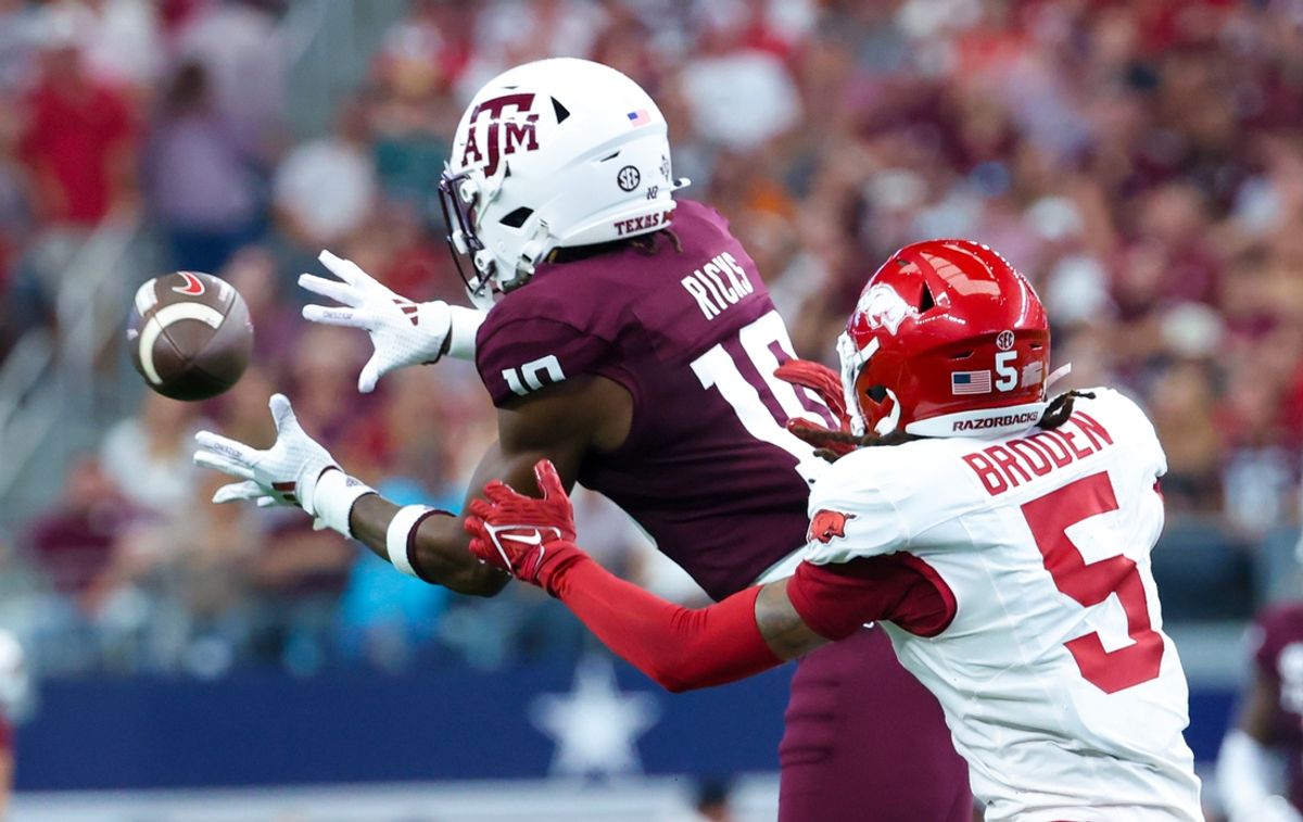 Sep 28, 2024; Arlington, Texas, USA;  Texas A&M Aggies defensive back Dezz Ricks (10) intercepts a pass intended for Arkansas Razorbacks wide receiver Tyrone Broden (5) during the first half at AT&T Stadium. Mandatory Credit: Kevin Jairaj-Imagn Images