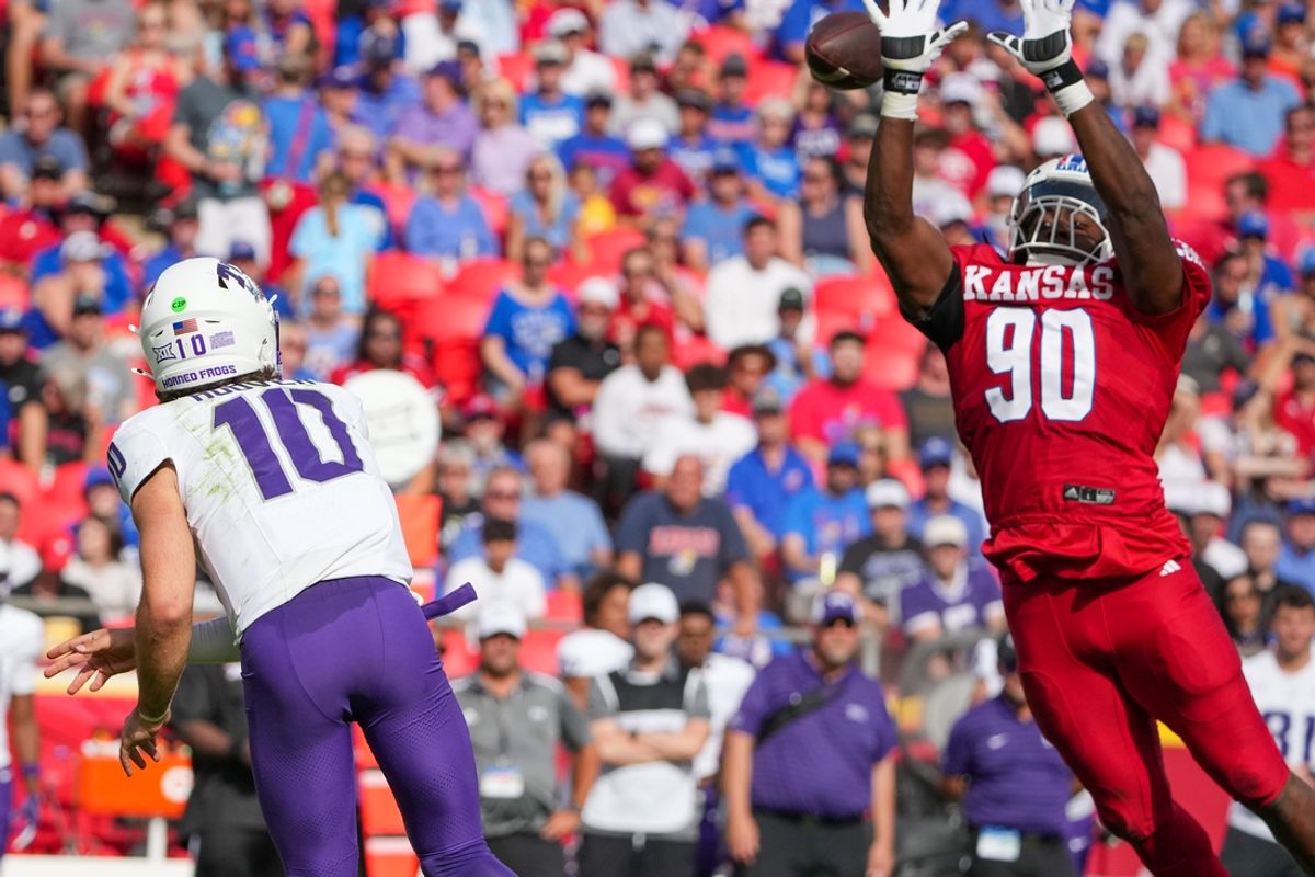 Sep 28, 2024; Kansas City, Missouri, USA; Kansas Jayhawks defensive end Jereme Robinson (90) tries to block the pass from TCU Horned Frogs quarterback Josh Hoover (10) during the first half at GEHA Field at Arrowhead Stadium. Mandatory Credit: Denny Medley-Imagn Images