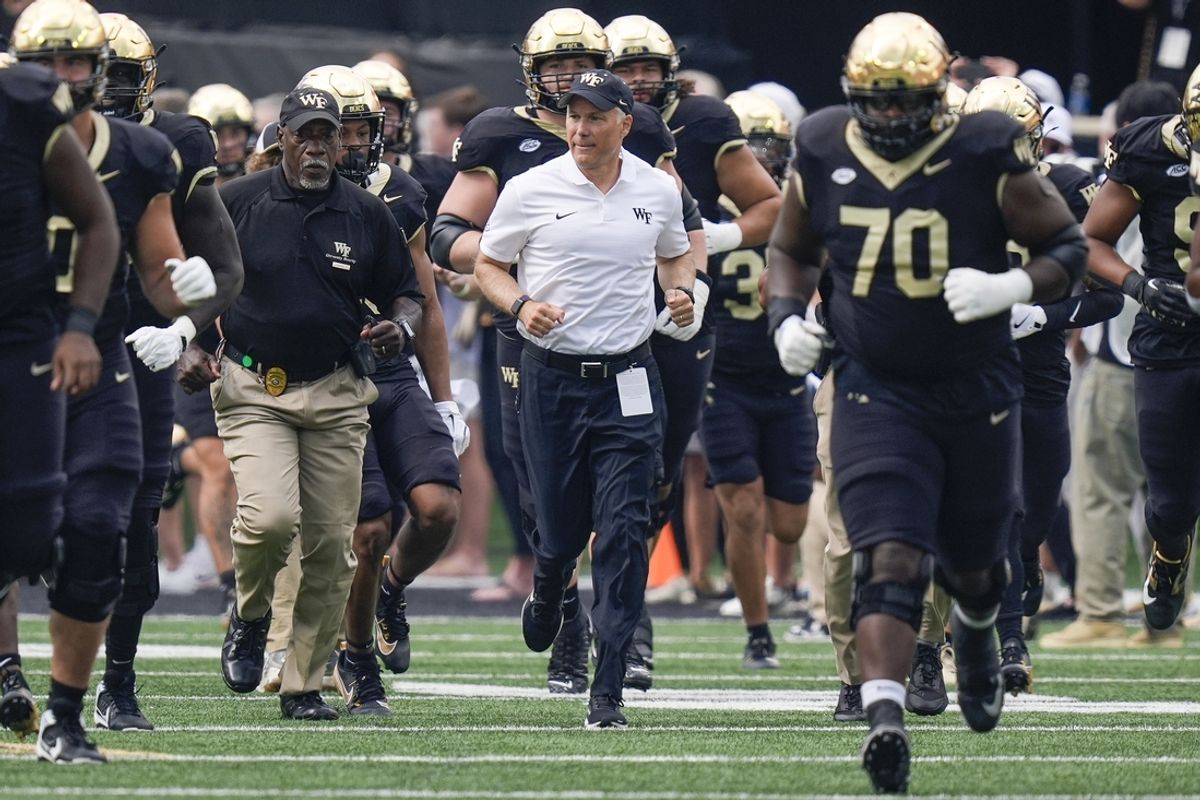 Sep 28, 2024; Winston-Salem, North Carolina, USA;  Wake Forest Demon Deacons head coach Dave Clawson leads his team onto the field against the Louisiana-Lafayette Ragin Cajuns during the first half at Allegacy Federal Credit Union Stadium. Mandatory Credit: Jim Dedmon-Imagn Images
