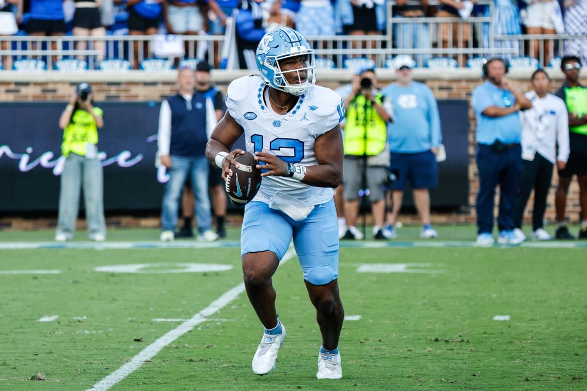 Sep 28, 2024; Durham, North Carolina, USA;  North Carolina Tar Heels quarterback Jacolby Criswell (12) runs with the ball during the first half of the game against Duke Blue Devils at Wallace Wade Stadium. Mandatory Credit: Jaylynn Nash-Imagn Images
