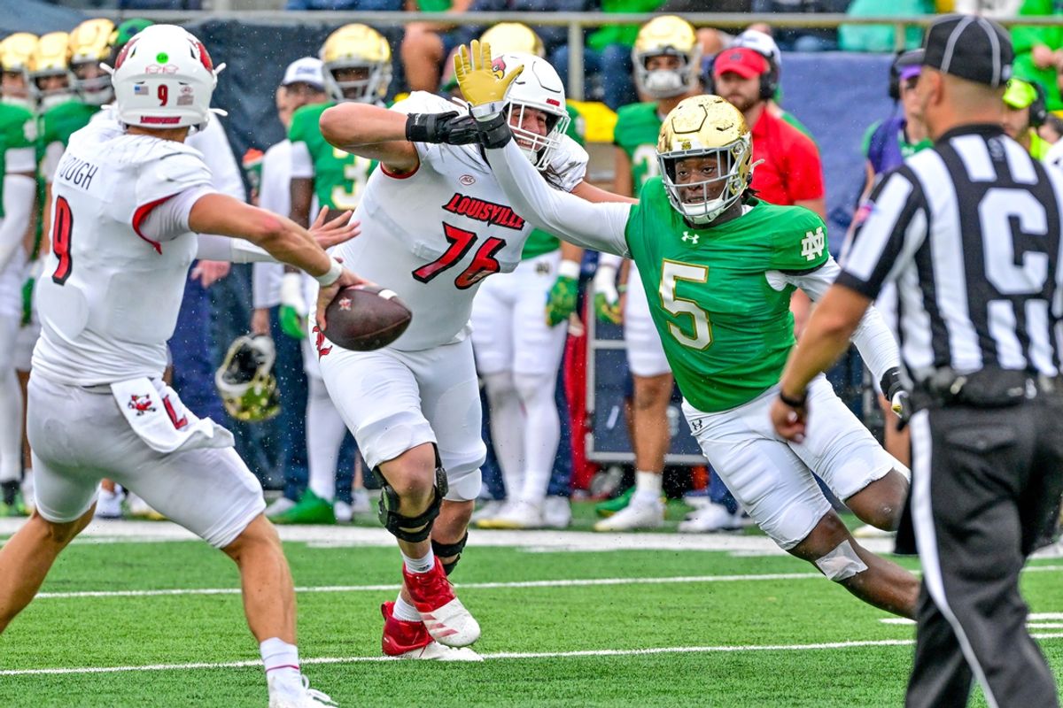 Sep 28, 2024; South Bend, Indiana, USA; Notre Dame Fighting Irish defenisve lineman Boubacar Traore (5) pressures Louisville Cardinals quarterback Tyler Shough (9) in the first quarter at Notre Dame Stadium. Mandatory Credit: Matt Cashore-Imagn Images
