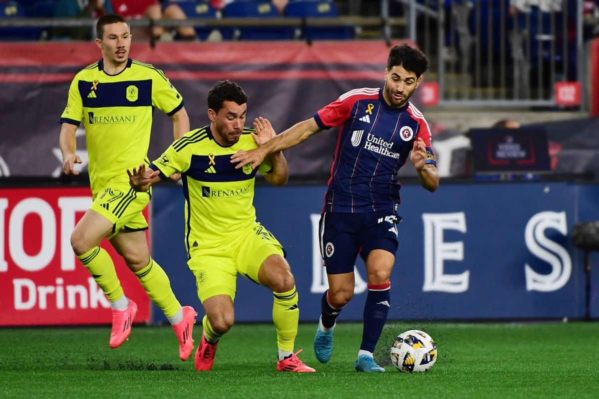 Sep 28, 2024; Foxborough, Massachusetts, USA; Nashville SC defender Daniel Lovitz (2) and New England Revolution midfielder Carles Gil (10) battle for the ball in the first half at Gillette Stadium. Mandatory Credit: Bob DeChiara-Imagn Images
