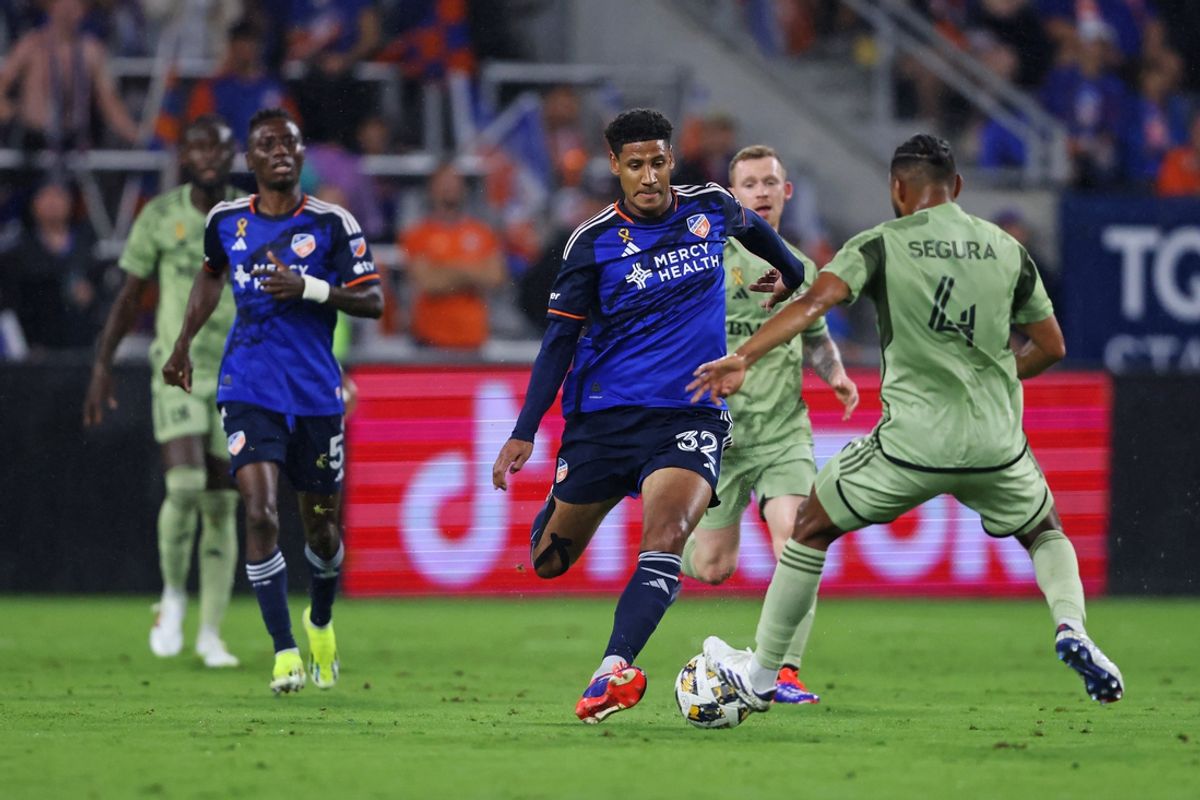 Sep 28, 2024; Cincinnati, Ohio, USA; FC Cincinnati defender London Aghedo (34) controls the ball as LAFC defender Eddie Segura (4) defends during the first half at TQL Stadium. Mandatory Credit: Joseph Maiorana-Imagn Images