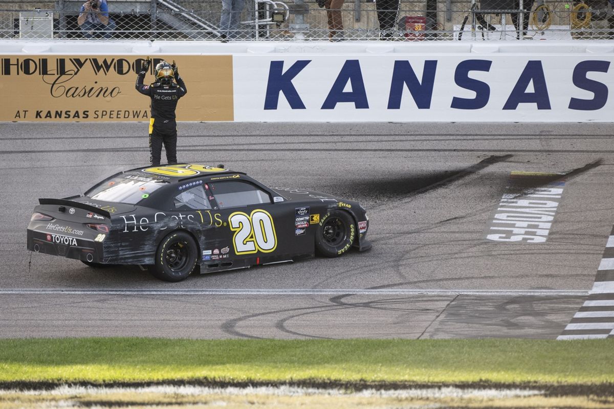 Sep 28, 2024; Kansas City, Kansas, USA; NASCAR Xfinity Series driver Aric Almirola (20) celebrates after winning the NASCAR Xfinity Series Race at Kansas Speedway. Mandatory Credit: Amy Kontras-Imagn Images