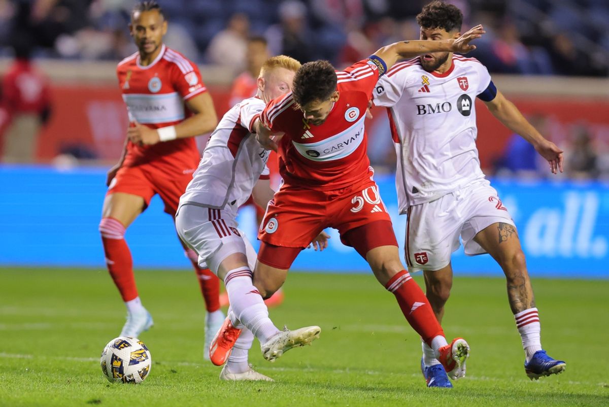 Sep 28, 2024; Chicago, Illinois, USA; Chicago Fire FC midfielder Gaston Gimenez (30) and Toronto FC midfielder Matty Longstaff (8) battles for the ball during the second half  at SeatGeek Stadium. Mandatory Credit: Melissa Tamez-Imagn Images