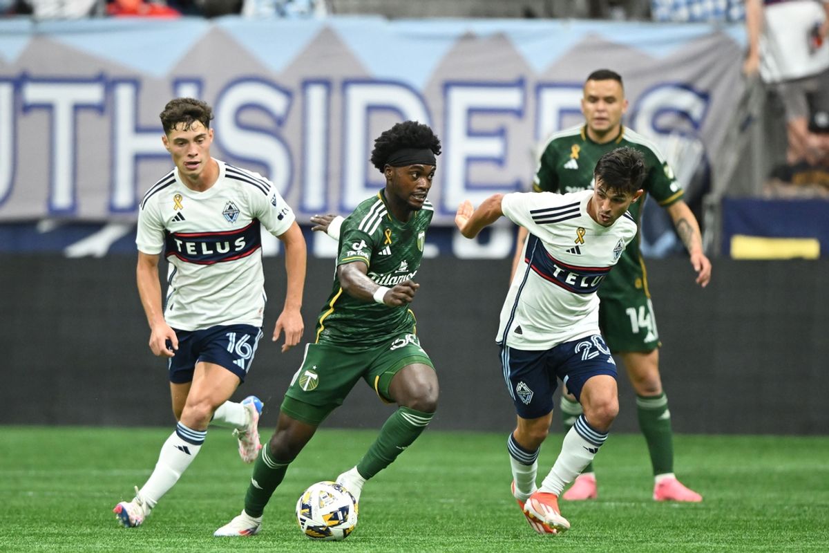 Sep 28, 2024; Vancouver, British Columbia, CAN; Vancouver Whitecaps FC midfielder Sebastian Berhalter (16) and midfielder Andres Cubas (20) battle for the ball against Portland Timbers forward Santiago Moreno (30) in the first half at BC Place. Mandatory Credit: Anne-Marie Sorvin-Imagn Images